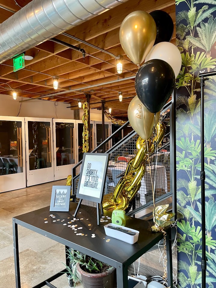 Balloons and check-in table for birthday celebration. Our event space is highly configurable for celebrations, baby showers, school auctions, receptions, company off-sites and workshops, and for creating community.